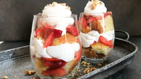 two strawberry parfaits on tray.