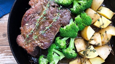 oven baked chuck roast recipe in cast iron skillet with potatoes and broccoli