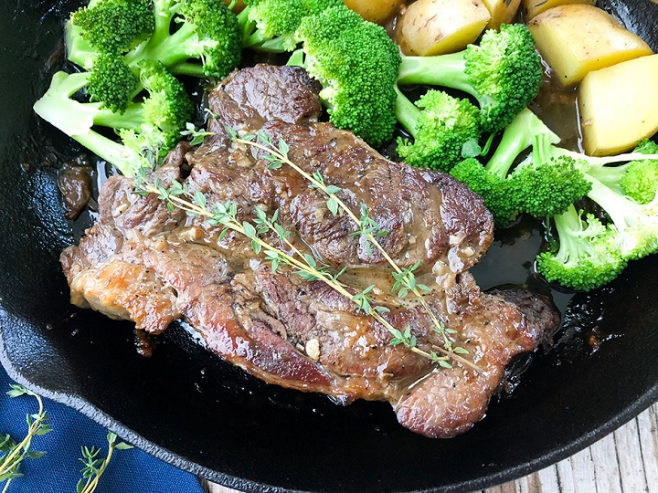 close up shot oven baked chuck roast recipe in skillet with veggies