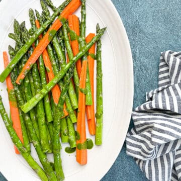 roasted asparagus and carrots on white serving dish.