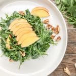 frontal view of simple arugula salad with nectarines