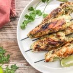 grilled chicken skewers served on a white plate