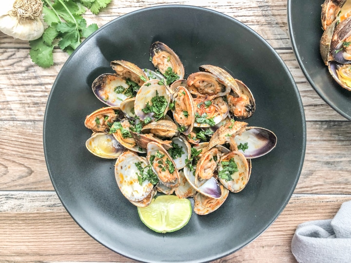 over head shot of steamed clams in black bowl 