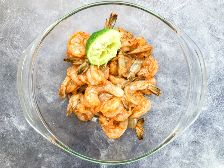 raw shrimp in mixing bowl seasoned with cuban spices for shrimp bowl recipe