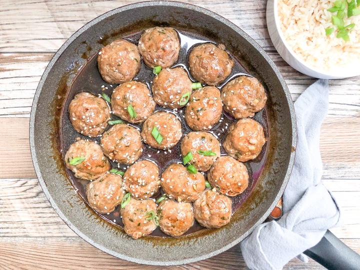 easy teriyaki meatballs in skillet with a side of rice in a bowl