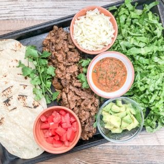 soft taco recipe with flap meat and toppings on rustic baking sheet
