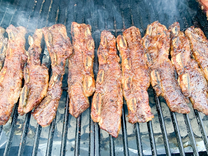 grilled ribs with a little smoke coming from grill