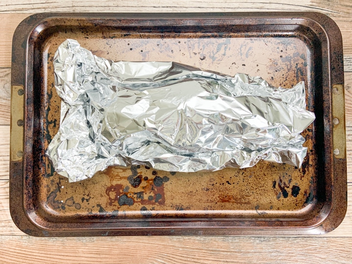 foil pouch with beets inside sitting on baking sheet