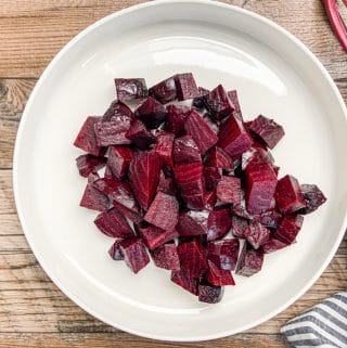roasted beets cut into chucks on white plate