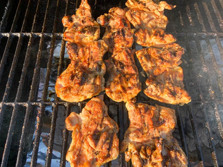 chicken thighs on charcoal grill with gill marks
