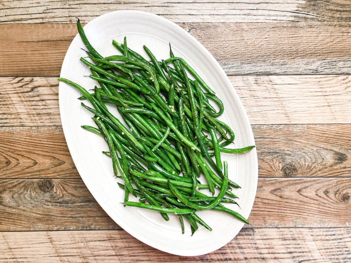 green beans on white serving platter