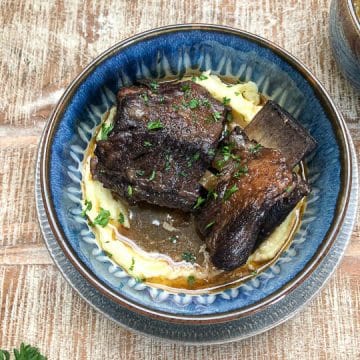 braised beef short ribs in blue bowl