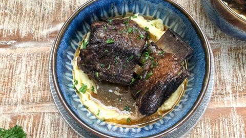 braised beef short ribs in blue bowl