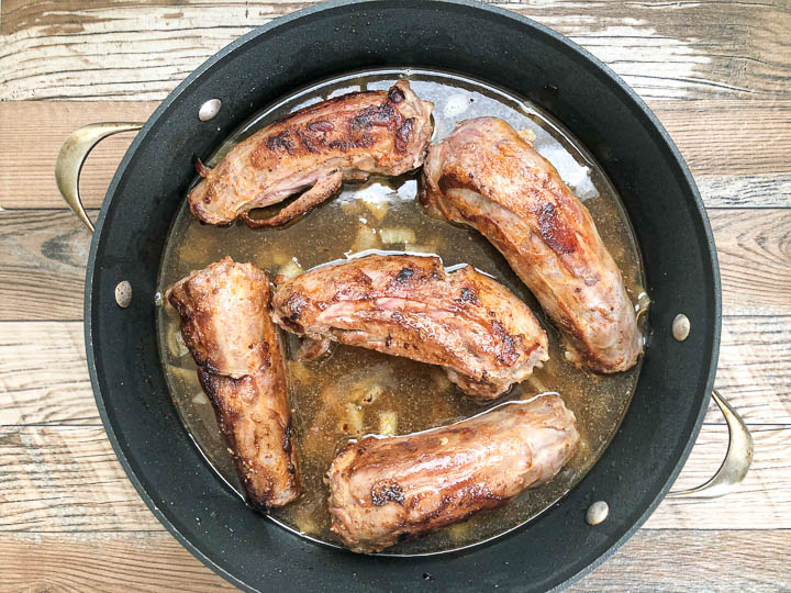 chicken broth added to dutch oven with turkey necks