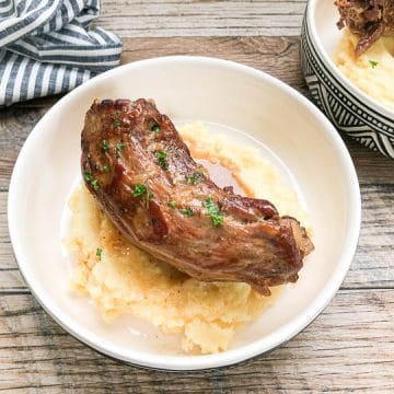 turkey neck on top of garlic mashed potatoes