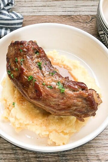 turkey neck on top of garlic mashed potatoes