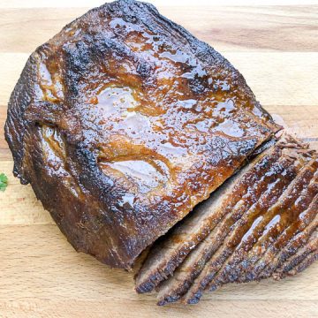 braised brisket cut into slices on cutting board