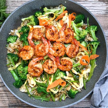 vegetable fried rice topped with seared shrimp