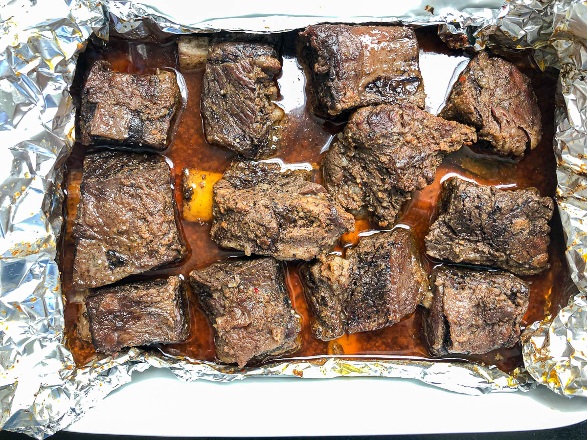foil unwrapped showing beef short ribs after being cooked for several hours