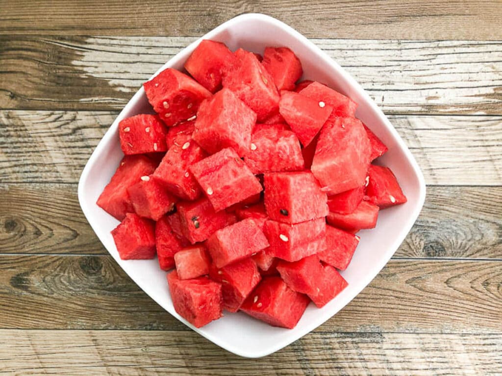 watermelon cut into cube in square white bowl