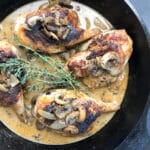 roasted cornish hens in white wine sauce in cast iron skillet