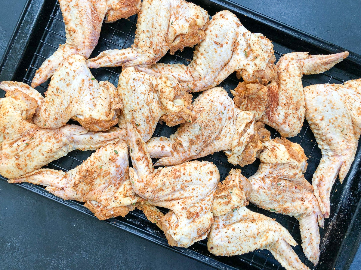 raw chicken wings on baking rack.