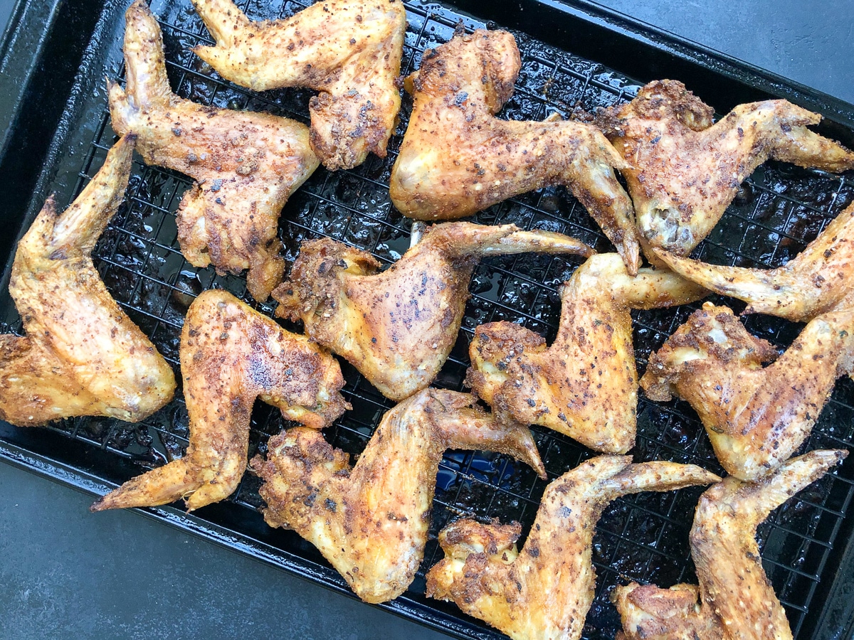 crispy wings cooling on baking rack.