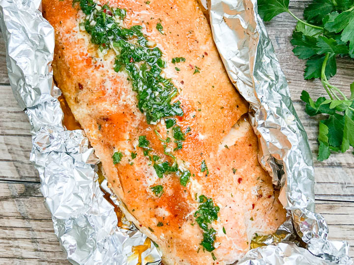 grilled salmon in foil with chimichurri.