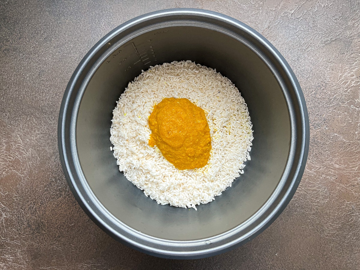 uncooked rice and saffron turmeric mixture that was heated now added to rice insert.