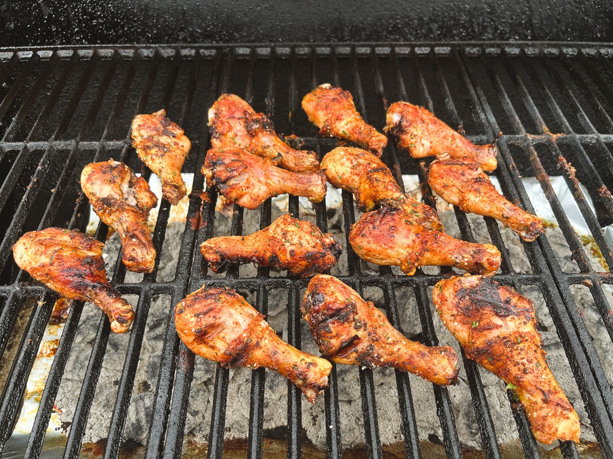chicken legs on grill grates.