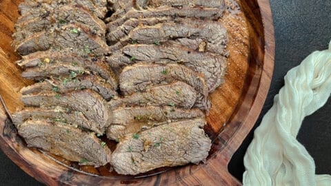 close-up image of sliced tri-tip on serving tray.