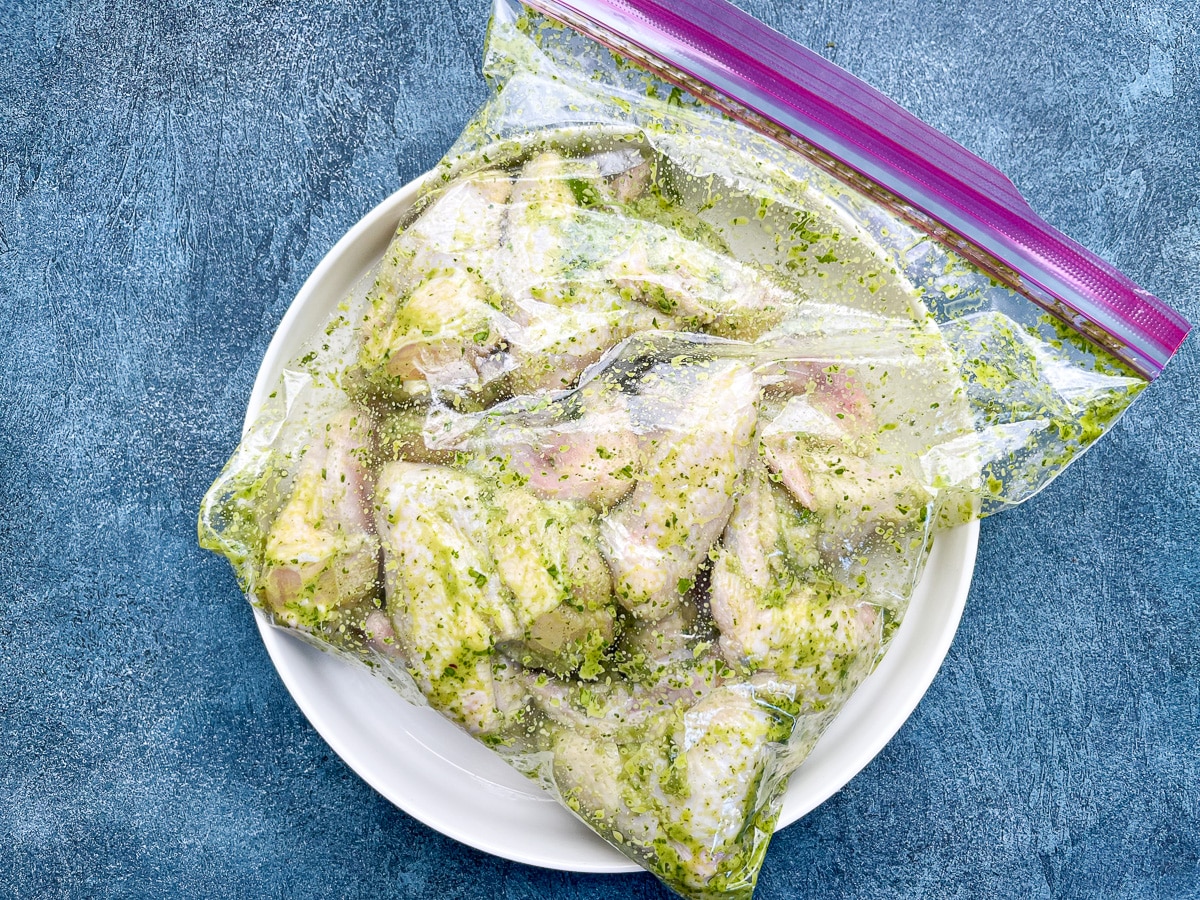 whole chicken wings marinating in ziploc bag.