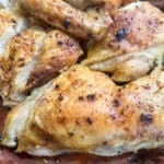 Juicy roasted Cajun spatchcock chicken carved and served on a platter.