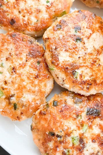 Close-up image of salmon croquettes on a white plate.