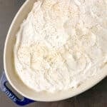 Old-fashioned homemade vanilla pudding topped with whipped cream and crushed Nilla wafers.