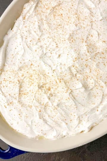 Old-fashioned homemade vanilla pudding topped with whipped cream and crushed Nilla wafers.