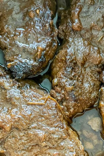 Close-up of tender braised boneless short ribs with rich gravy.