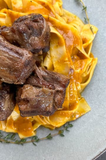 Tender oxtails on a gray plate.
