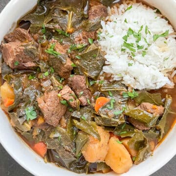 Overhead view of Southern beef stew served in a bowl with a scoop of white rice, featuring tender chunks of beef and vegetables in a rich, dark brown broth.